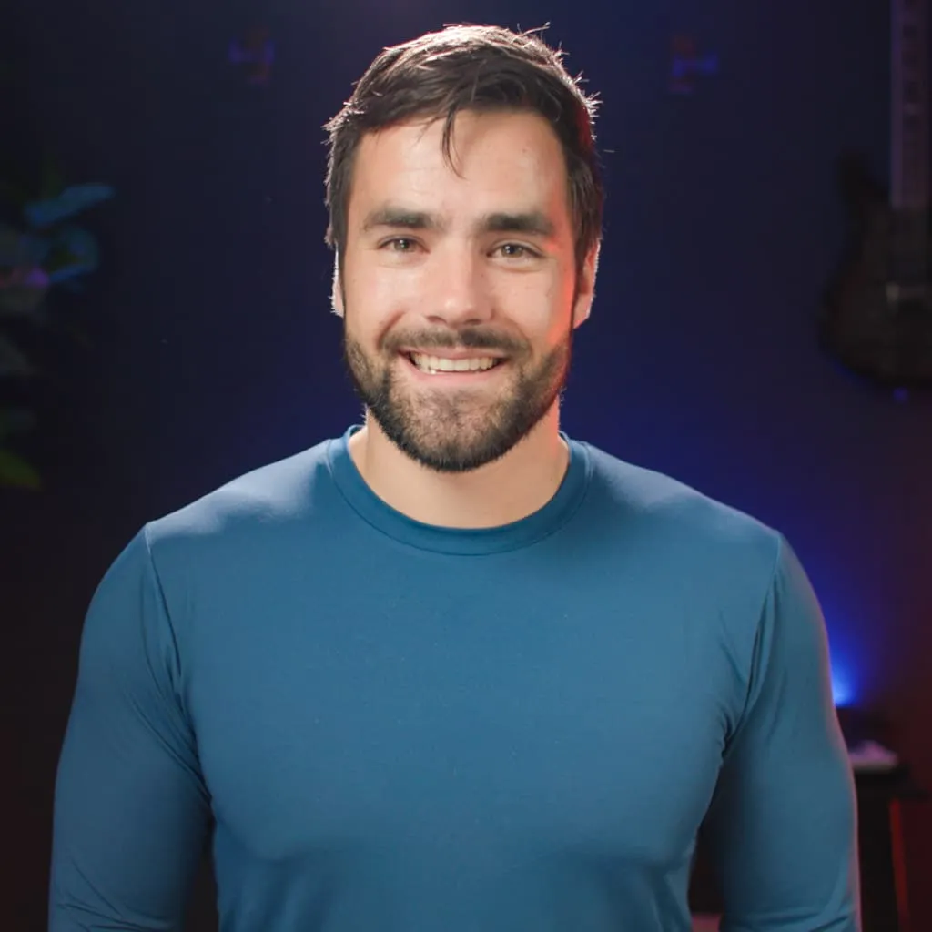 Thomas Frank smiling in a studio portrait
